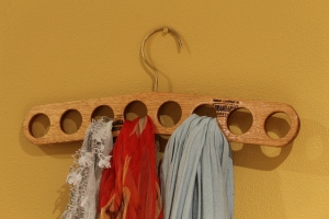 Wooden scarf hanger with sturdy brass hook.
